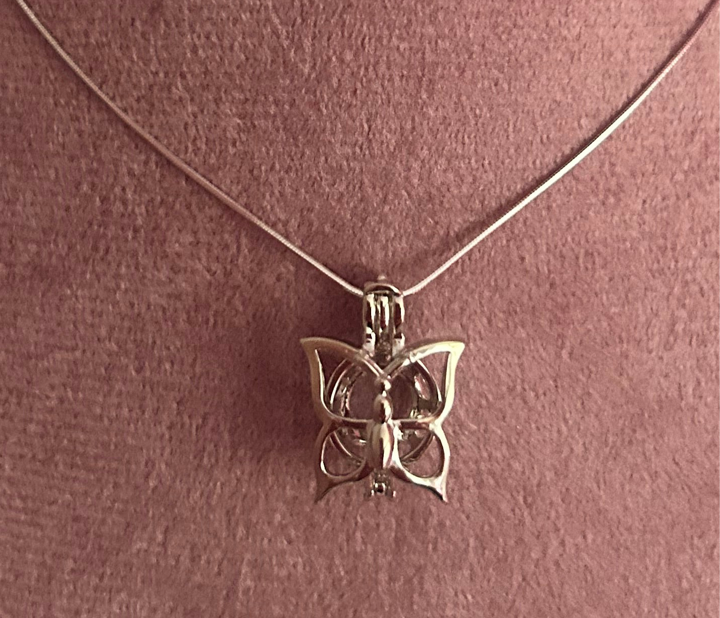 Silver plated butterfly cage pendant