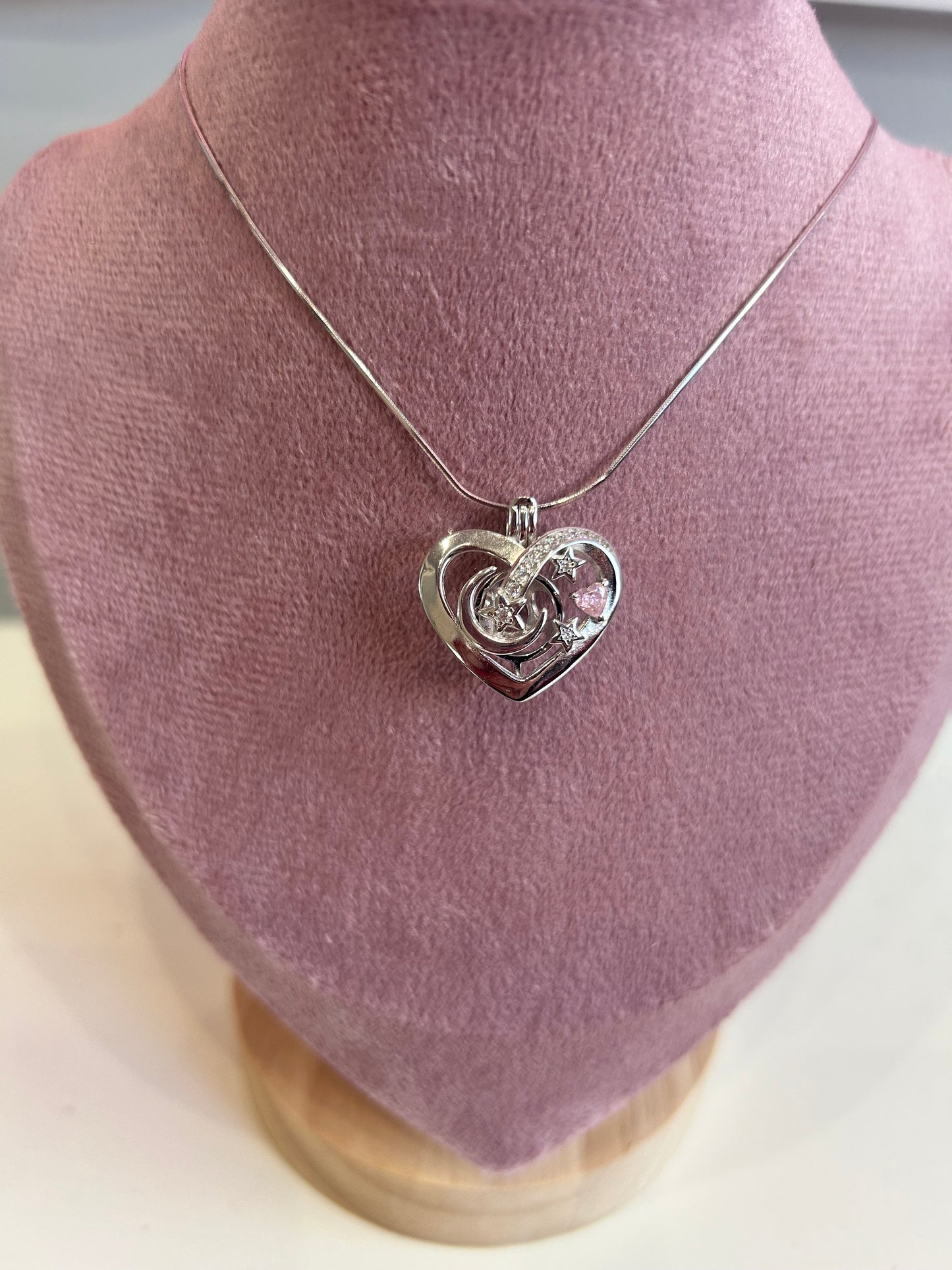 Sterling silver love heart moon and stars cage pendant with pink cubic zirconia