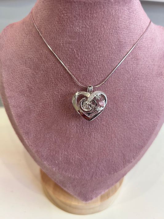 Sterling silver love heart moon and stars cage pendant with pink cubic zirconia