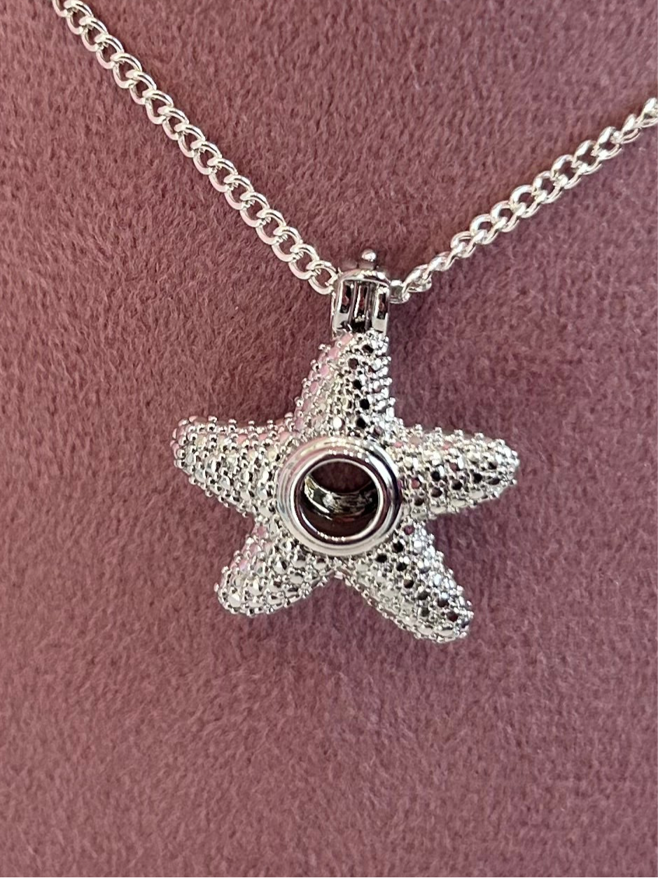 Silver plated starfish cage pendant