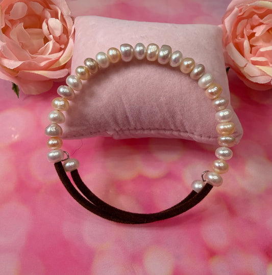 Peach and white potato pearl bracelet with brown cord