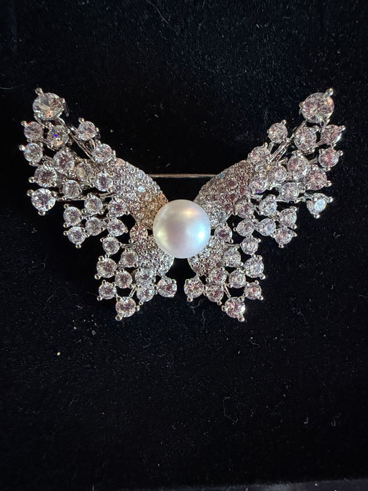 Plated butterfly broach with cubic zirconia and a white button pearl